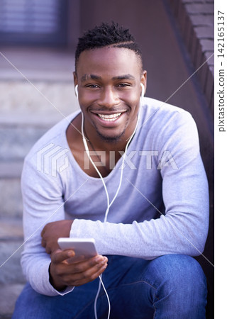 Black man, portrait and cellphone with earphones on stairs in city or music subscription, travel or relax. Male person, face and smartphone on downtown street in Atlanta or podcast, playlist or track Black man, portrait and cellphone with earphones on stairs in city or music subscription, travel or relax. Male person, face and smartphone on downtown street in Atlanta or podcast, playlist or track 142165137