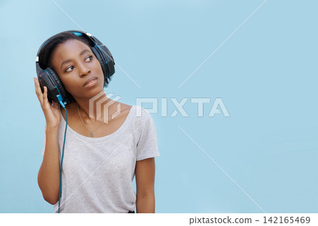 Thinking, music or headphones by black woman with mockup for sound, track or listening to podcast on blue background. Streaming, announcement or gen z student with radio, playlist or audio ebook 142165469