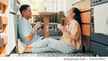 Coffee, talking and couple on the floor, home and care with laughing or communication with relationship. Apartment, woman or man with tea, joke and funny with happiness, humor or commitment on ground 142165647