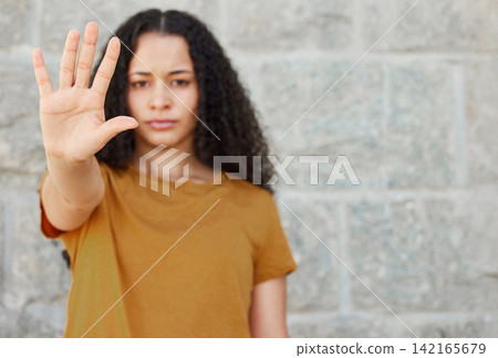 Stop, hand and portrait of woman for warning, rejection or sign against wall. Serious, gesture and face of gen z female person for sexual harassment, discrimination or gender equality in outdoor Stop, hand and portrait of woman for warning, rejection or sign against wall. Serious, gesture and face of gen z female person for sexual harassment, discrimination or gender equality in outdoor 142165679