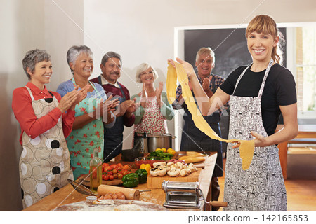 Cooking, pasta and portrait of people in kitchen learning recipe for cuisine, culinary and chef skills. Retirement, teacher and and men and women with pastry ingredients, dough and food for dinner Cooking, pasta and portrait of people in kitchen learning recipe for cuisine, culinary and chef skills. Retirement, teacher and and men and women with pastry ingredients, dough and food for dinner 142165853
