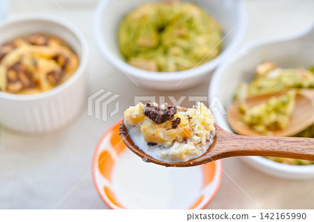 Scoop cookies to eat by dipping them in milk. Scoop cookies to eat by dipping them in milk. 142165990