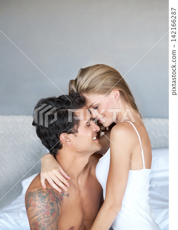 Couple, relax and hug on hotel bed, smile and romance bonding in home for relationship. Happy people, embrace and security in marriage connection, care and eye contact for love on morning together Couple, relax and hug on hotel bed, smile and romance bonding in home for relationship. Happy people, embrace and security in marriage connection, care and eye contact for love on morning together 142166287