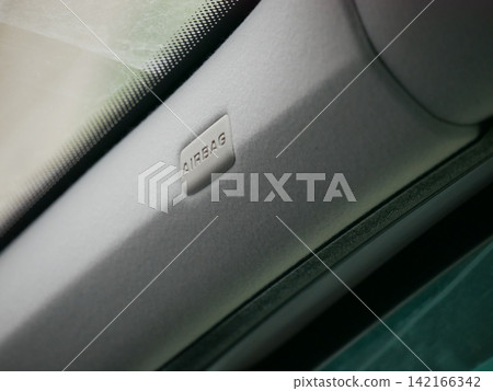 Car airbag label on vehicle pillar. Safety system indicator inside interior. Protection technology for passenger in automotive transport. Emergency security equipment for road travel. Car airbag label on vehicle pillar. Safety system indicator inside interior. Protection technology for passenger in automotive transport. Emergency security equipment for road travel. 142166342