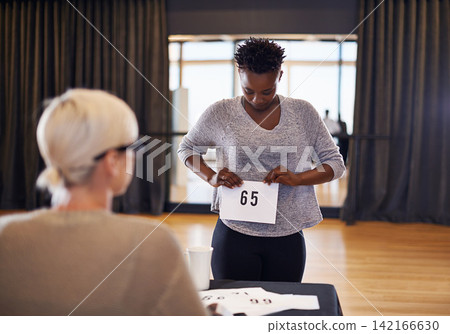 Number, judge and woman in casting audition to sign up for performance or acting on a stage in theater. Happy actress, competition or dancer ready for dancing at academy in talent show in auditorium Number, judge and woman in casting audition to sign up for performance or acting on a stage in theater. Happy actress, competition or dancer ready for dancing at academy in talent show in auditorium 142166630