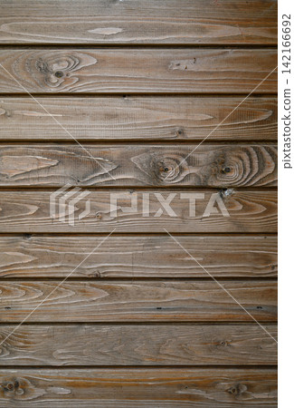 Rustic wooden wall showcases intricate textures and warm tones in a cozy indoor setting Rustic wooden wall showcases intricate textures and warm tones in a cozy indoor setting 142166692