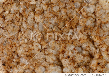 Macro close-up texture of a puffed rice cake with seasoning Macro close-up texture of a puffed rice cake with seasoning 142166743