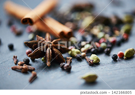 Closeup of whole spices, mix of ingredients and cooking for food, fragrance and flavor with culinary background. Stick cinnamon, star anise and peppercorn for catering, seasoning collection and aroma Closeup of whole spices, mix of ingredients and cooking for food, fragrance and flavor with culinary background. Stick cinnamon, star anise and peppercorn for catering, seasoning collection and aroma 142166805