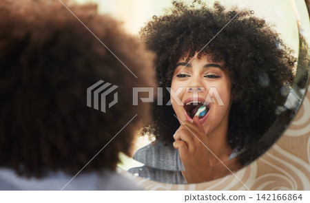 Dental, mirror and woman brushing teeth in bathroom for health, wellness and self care in morning at home. Oral care, reflection and female person with mouth routine or treatment in apartment. Dental, mirror and woman brushing teeth in bathroom for health, wellness and self care in morning at home. Oral care, reflection and female person with mouth routine or treatment in apartment. 142166864