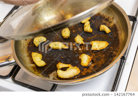 stainless steel frying pan with burnt chicken breast pieces stainless steel frying pan with burnt chicken breast pieces 142167764
