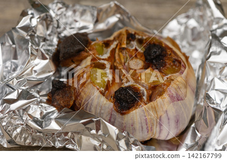 Roasted Garlic Head in Aluminum Foil Roasted Garlic Head in Aluminum Foil 142167799