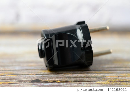 Compact black travel adapter showcasing sleek design for global connectivity Compact black travel adapter showcasing sleek design for global connectivity 142168011