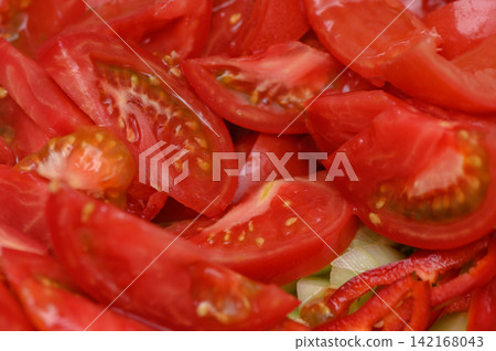 Freshly sliced tomatoes invite vibrant meals and colorful salads Freshly sliced tomatoes invite vibrant meals and colorful salads 142168043
