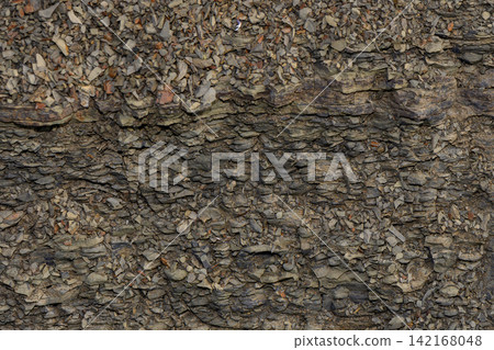 Textured close-up of fractured stone strata and granular debris Textured close-up of fractured stone strata and granular debris 142168048