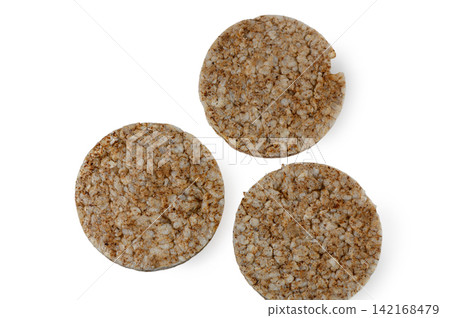 Three round whole grain rice cakes arranged separately on a white background 142168479
