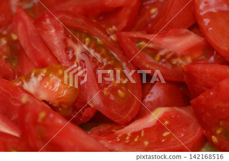 Fresh red tomato slices glistening with juice, ready to enhance any dish with vibrant flavor and color 142168516