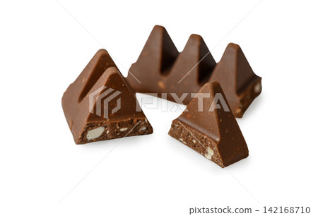 Broken pieces of Toblerone milk chocolate with visible almond and honey nougat on a white background Broken pieces of Toblerone milk chocolate with visible almond and honey nougat on a white background 142168710