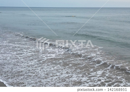 Drone View of Corolla Beach With a Swimmer in the Ocean During Vacation Drone View of Corolla Beach With a Swimmer in the Ocean During Vacation 142168931