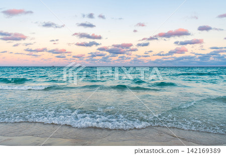 Calm horizon view at sea sunrise. Romantic summer vacation sunrise on seascape. Sea horizon view. Cloudy sky and seascape at summer vacation. Skyscape with sea horizon. Sunset on the horizon Calm horizon view at sea sunrise. Romantic summer vacation sunrise on seascape. Sea horizon view. Cloudy sky and seascape at summer vacation. Skyscape with sea horizon. Sunset on the horizon 142169389