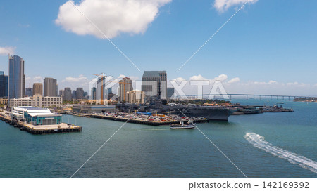 San Diego, California, USA - May 17, 2019: Aircraft carrier navy ship at sea bay. Midway aircraft carrier museum of USA naval. Military ship. USS Midway aircraft carrier museum, United States Navy San Diego, California, USA - May 17, 2019: Aircraft carrier navy ship at sea bay. Midway aircraft carrier museum of USA naval. Military ship. USS Midway aircraft carrier museum, United States Navy 142169392