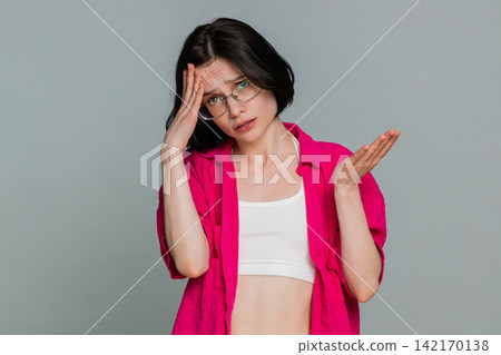 Woman sighs with disappointment covering face expressing sadness after failure or bad news reaction Woman sighs with disappointment covering face expressing sadness after failure or bad news reaction 142170138