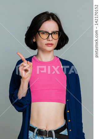 Woman shaking head with palm raised clearly showing disagreement refusal rejection negative sign Woman shaking head with palm raised clearly showing disagreement refusal rejection negative sign 142170152