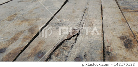 Old cracked wooden plank with rusty nails Old cracked wooden plank with rusty nails 142170158