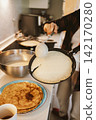 Pouring Pancake Batter into Skillet for Breakfast Cooking 142170280