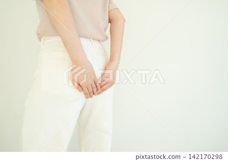 Woman suffering from anal pain and discomfort. Cause of pain include hemorrhoid, anal fissure, diarrhea, constipation or Crohn's disease. Gastrointestinal system concept. Woman suffering from anal pain and discomfort. Cause of pain include hemorrhoid, anal fissure, diarrhea, constipation or Crohn's disease. Gastrointestinal system concept. 142170298