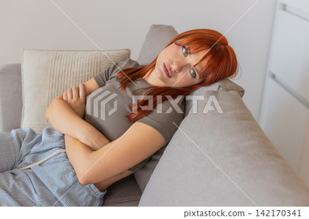 Young woman with laptop looks exhausted bad mood after tough news silent stare long pause heavy sigh 142170341