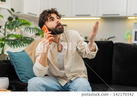 Indian man smartphone night spam call angry tired user ending conversation hangs up frustrated quick Indian man smartphone night spam call angry tired user ending conversation hangs up frustrated quick 142170342
