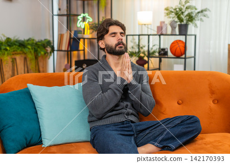 Indian man with closed eyes whispers prayer quiet ask calm mood peaceful hope hands gesture softly Indian man with closed eyes whispers prayer quiet ask calm mood peaceful hope hands gesture softly 142170393