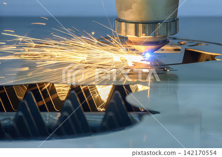 Close up of laser beam and splashing light at nozzle tip of fiber laser cutting machine Close up of laser beam and splashing light at nozzle tip of fiber laser cutting machine 142170554