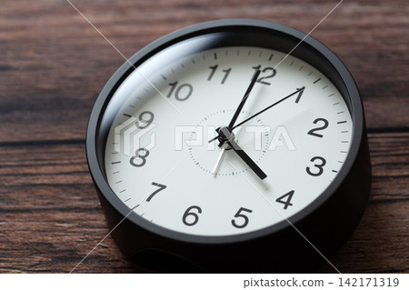 A clock showing 4 o'clock A clock showing 4 o'clock 142171319