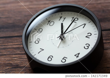 A clock showing 11 o'clock A clock showing 11 o'clock 142171349