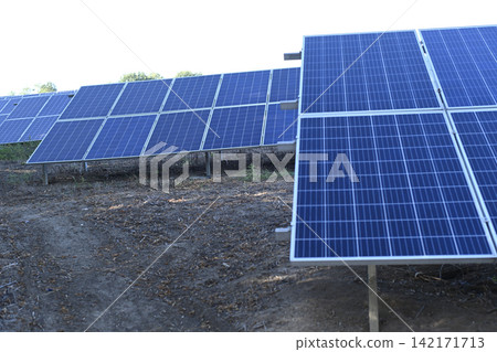 Large array of solar panels arranged in rows at solar energy farm, Large array of solar panels arranged in rows at solar energy farm, 142171713
