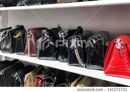Leather handbags in various colors displayed on store shelves, Leather handbags in various colors displayed on store shelves, 142171722