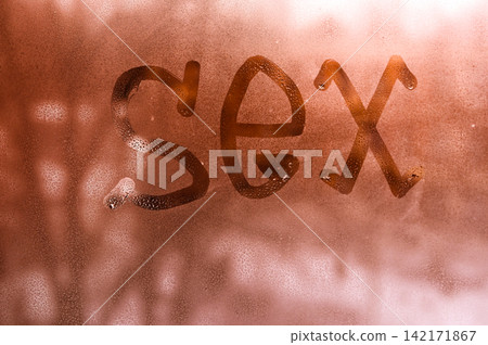 Handwritten provocative phrase stays on misty glass during winter morning. Handwritten provocative phrase stays on misty glass during winter morning. 142171867