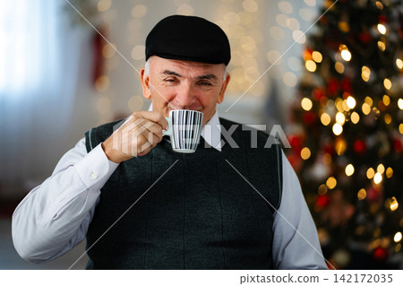 Senior man enjoying hot coffee during festive holiday season Senior man enjoying hot coffee during festive holiday season 142172035