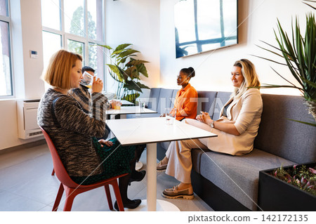 Business colleagues networking at casual office break area 142172135