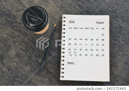 August 2026 desk calendar with disposable coffee cup and pen on wooden table. Directly above. Flat lay August 2026 desk calendar with disposable coffee cup and pen on wooden table. Directly above. Flat lay 142172443