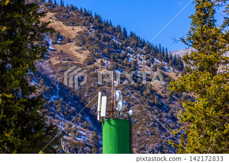 Communication Tower on Snowy Mountain Slope in Kyrgyzstan Communication Tower on Snowy Mountain Slope in Kyrgyzstan 142172833