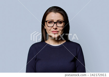 Close up portrait of smiling 40s mature woman in glasses studio shot 142172911
