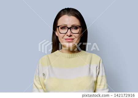 Close up portrait of confident 40s mature woman in glasses studio shot Close up portrait of confident 40s mature woman in glasses studio shot 142172916