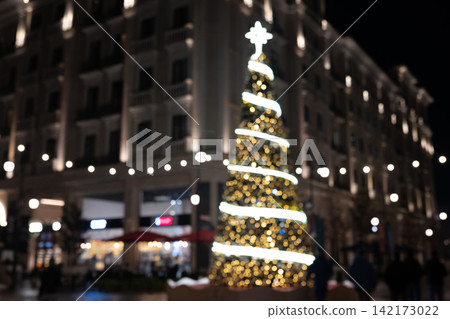 Christmas Tree with Twinkling Lights and Festive Bokeh in Modern City Christmas Tree with Twinkling Lights and Festive Bokeh in Modern City 142173022