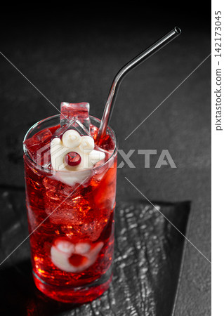 Spooky Halloween Red Cocktail Decorated with Ghostly Marshmallow and Cranberry with Metal Straw and Ice Cubes Spooky Halloween Red Cocktail Decorated with Ghostly Marshmallow and Cranberry with Metal Straw and Ice Cubes 142173045