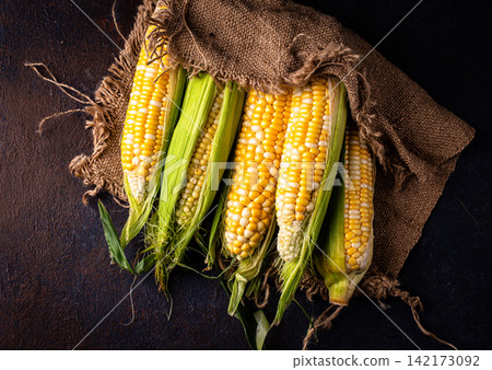 Raw uncooked fresh corn. Healthy food Raw uncooked fresh corn. Healthy food 142173092