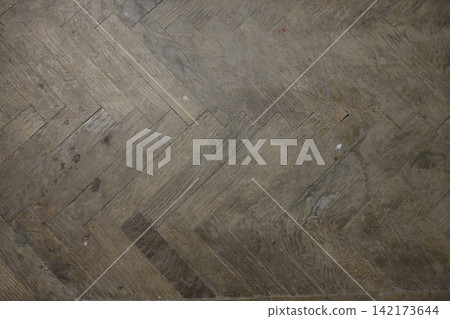 Herringbone wooden floor pattern inside an old building during the day Herringbone wooden floor pattern inside an old building during the day 142173644