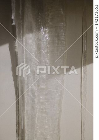 Clear ice formation hanging on a cold wall during a winter morning Clear ice formation hanging on a cold wall during a winter morning 142173653