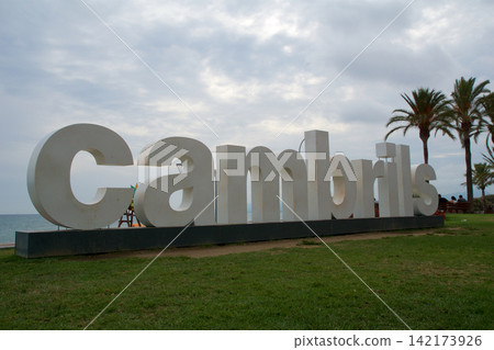 Cambrils, Spain, August 27 2017: Large Cambrils city sign at the promenade with palm trees Cambrils, Spain, August 27 2017: Large Cambrils city sign at the promenade with palm trees 142173926